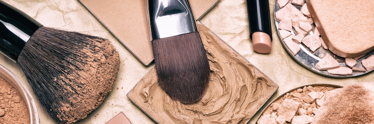 Why I Refuse to Cover My Rosacea Makeup products - powder, foundation, and makeup brushes