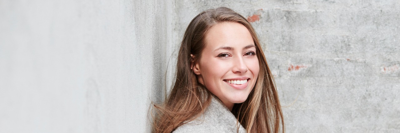 To Respect Me, You Need to Respect My Disease Portrait of woman in gray fashion against wall