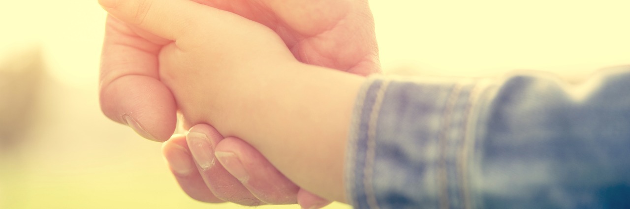 To My Dad, Who Modeled How to Live With Chronic Pain father and daughter holding hands