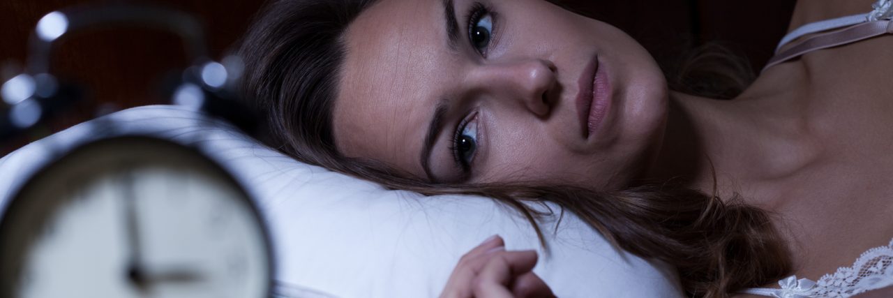 A Poem About My Insomnia Woman lying in bed suffering from insomnia
