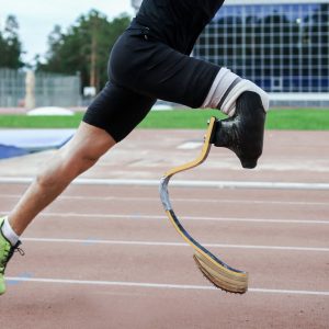 Athlete with prosthetic leg running.