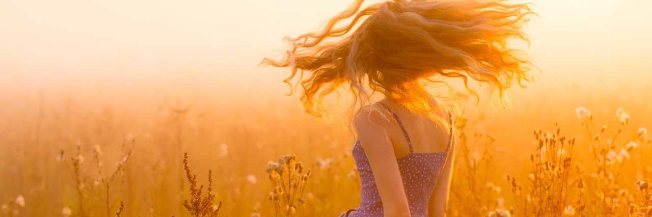 The Girl I Was Before: a Poem About Mental Health Recovery A woman in a field