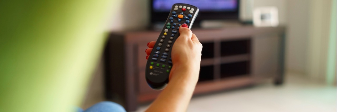 What You Don’t Know When You Say I Watch a Lot of Netflix Rear view of woman sitting in chair, holding remote control toward TV