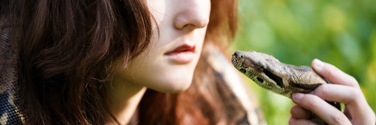 Explaining Depression in Prose Poem Teenage girl holding snake near face