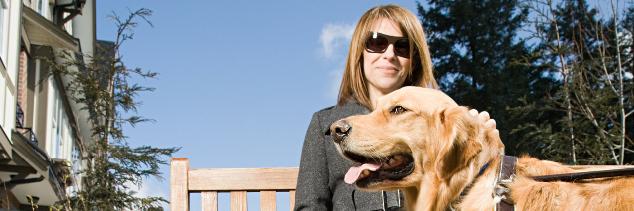 Dealing With 'Inspiration Porn' as a Blind Person Blind woman sitting on a bench on a sunny day with her golden retriever guide dog.