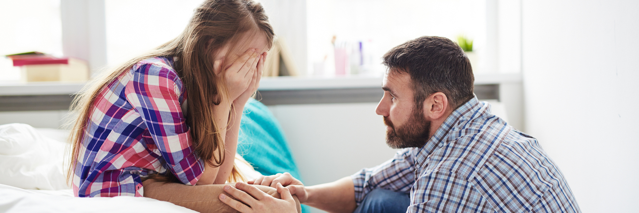 What You Need to Know If Your Child Is Diagnosed With Anxiety father supporting upset daughter at home