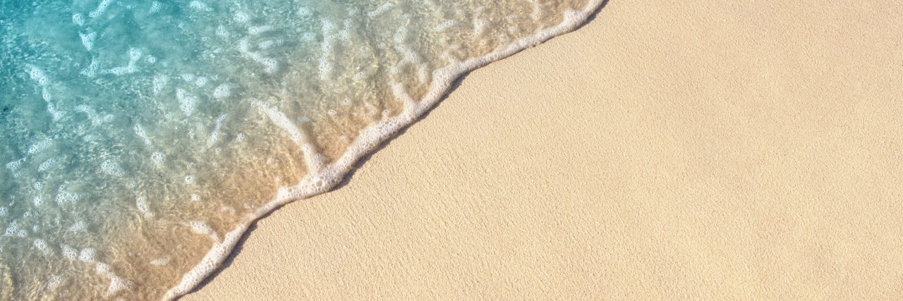 Getting Summer 'Beach Body' Is Triggering in Eating Disorder Recovery Soft wave of blue ocean on sandy beach, background