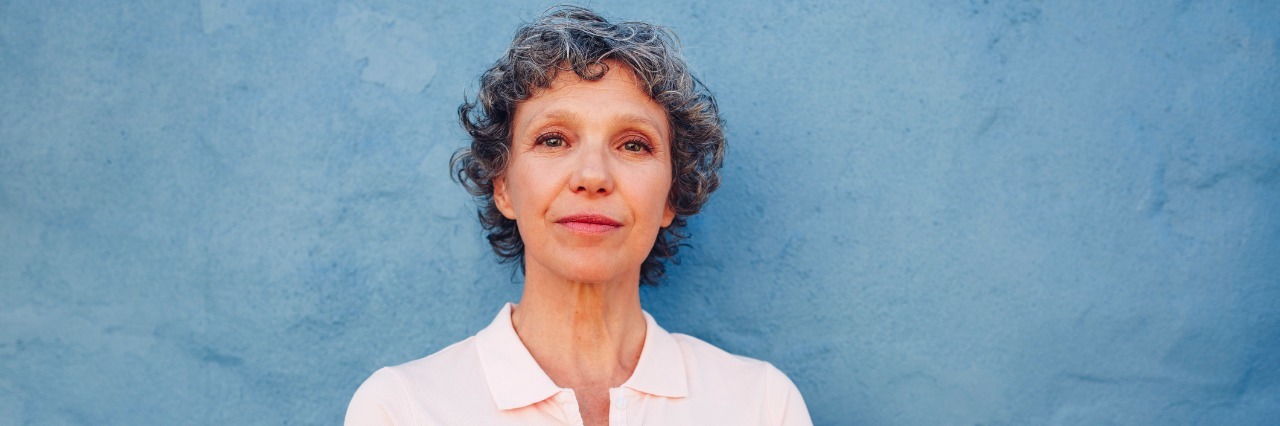 What to Say to a Sick Person Instead of 'You're So Strong' Confident mature woman standing with her arms crossed