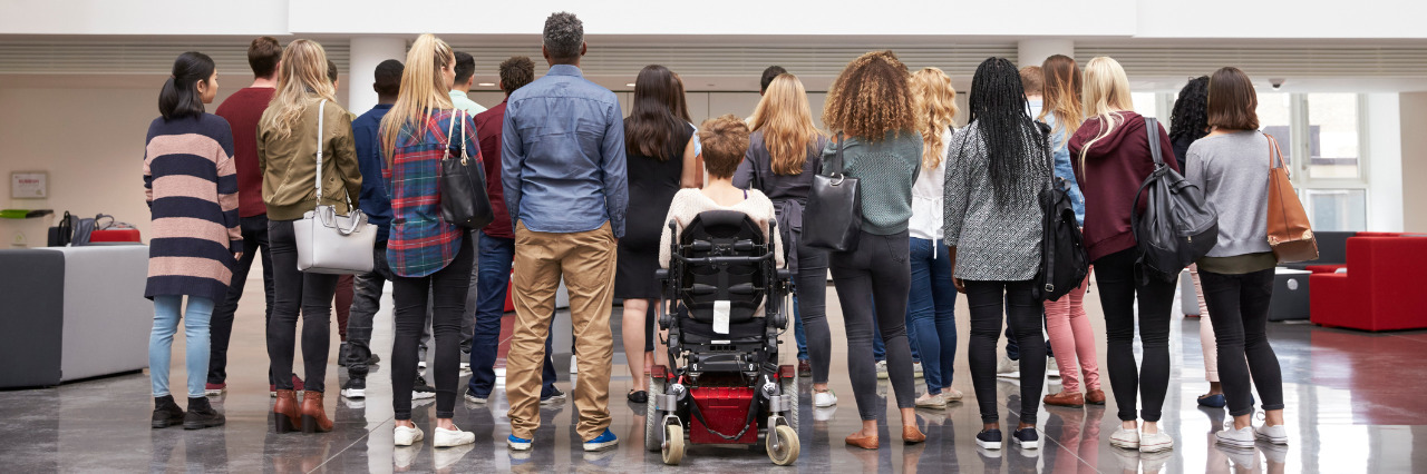 Disability Often Left Out of Conversations About Privilege Group of students blocking view of student in wheelchair.