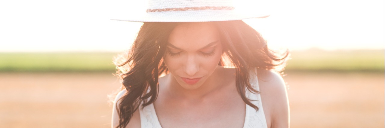 I'm Not Fine, I'm Functionally Ill Portrait of beautiful young woman with hat in the field