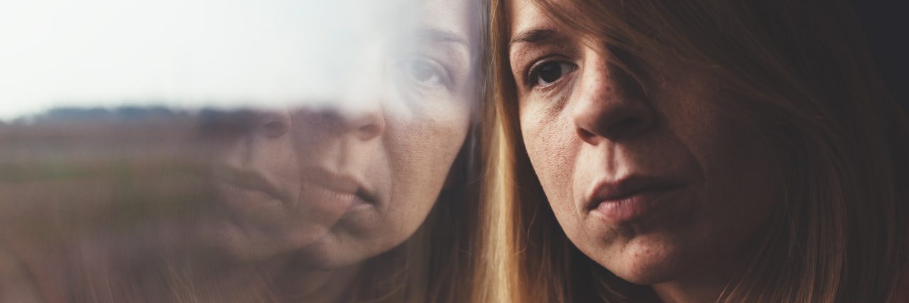 Depression Makes Me Feel More Than Just 'Tired' A woman in train alone and sad