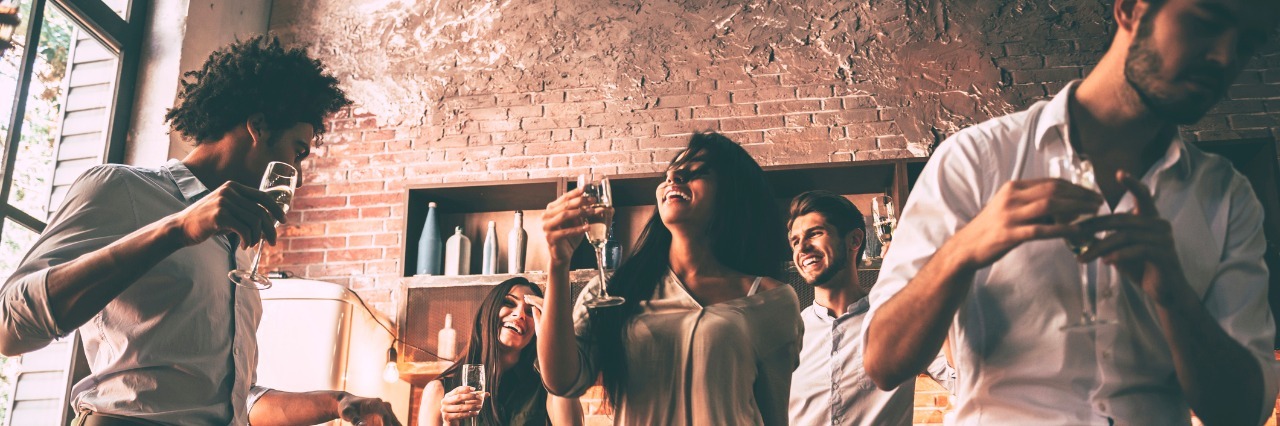 What I Do to Avoid Missing Get-Togethers Because of My Gastroparesis Low angle view of cheerful young people dancing and drinking while enjoying home party on the kitchen