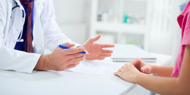 Doctor having a conversation with patient at desk