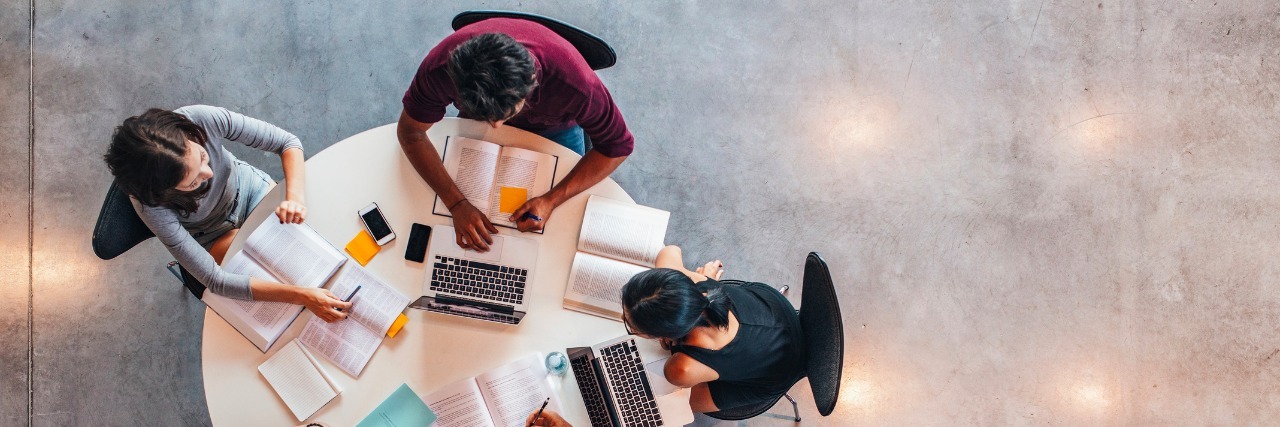 What's It's Like to Live With Mental Illness in College Top view of group of students sitting together at table. University students doing group study.