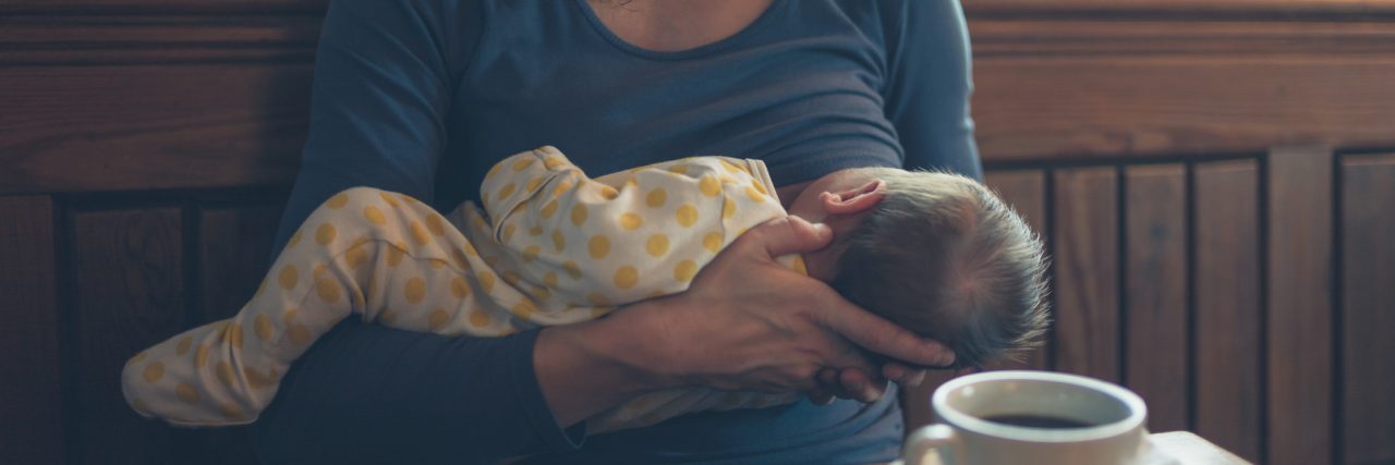 I Had a Painful Breastfeeding Condition I Didn't Know Existed: D-MER Woman breastfeeding baby in cafe