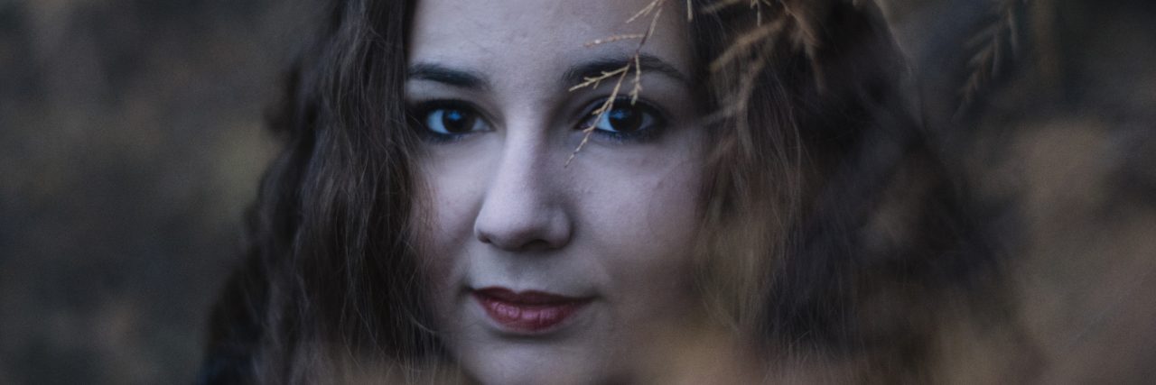 Why I Lie About Self-Harm (and What I Need From You) Young woman standing on fallen leaves