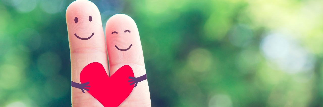 What It Means to Find Someone Else Who Has Chronic Health Issues two fingers with faces and a heart drawn on them