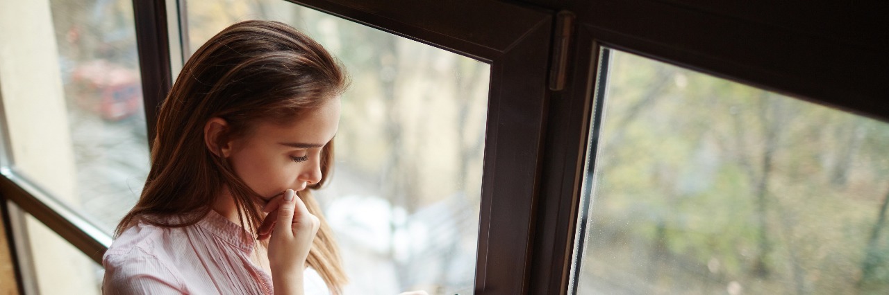 How to Survive Your School Year If You Have a Mental Illness female student reading text message on smartphone