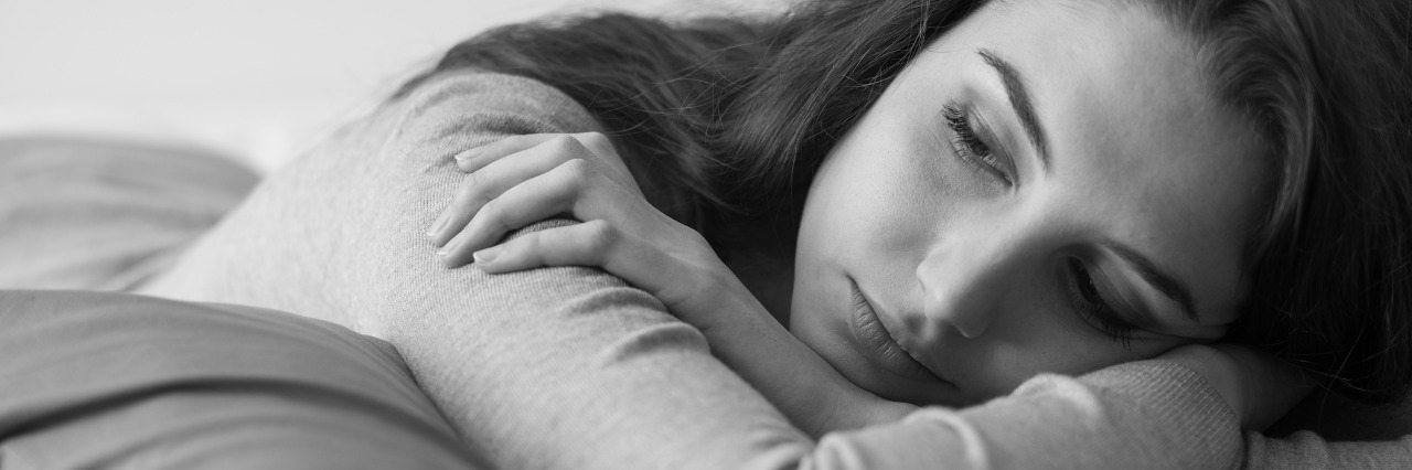 young woman lying on the bed at home