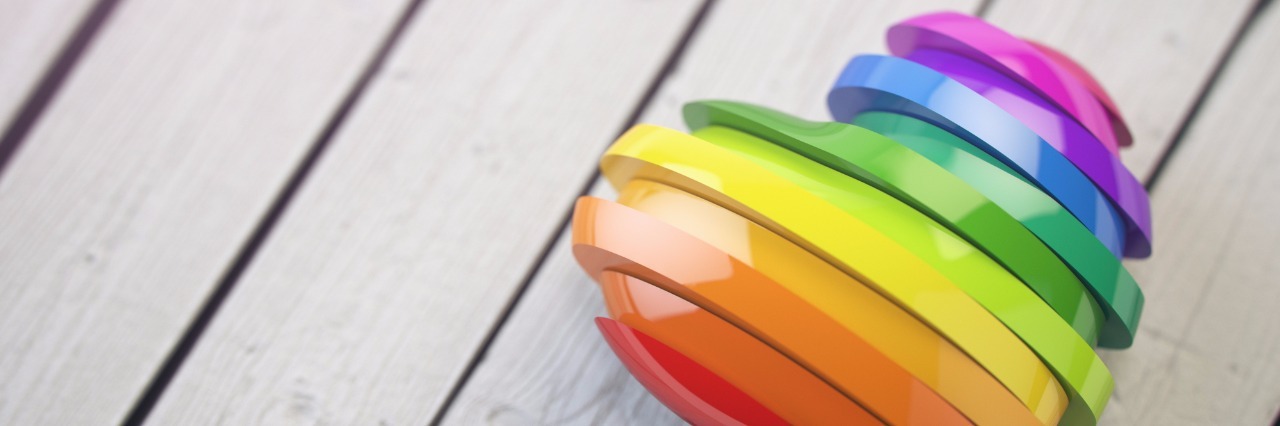 We Must Prioritize Mental Health Care for LGBTQ Identifying People Love valentine rainbow heart on a white wood background. Pride concept. 3d illustration