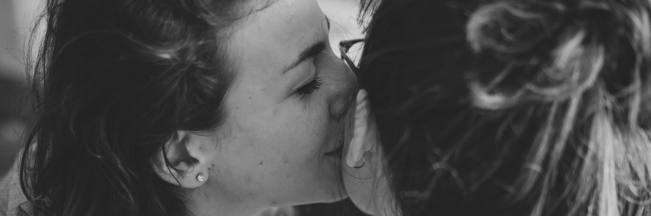 woman kissing wife on cheek