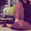 woman sitting on kitchen floor next to dishwasher