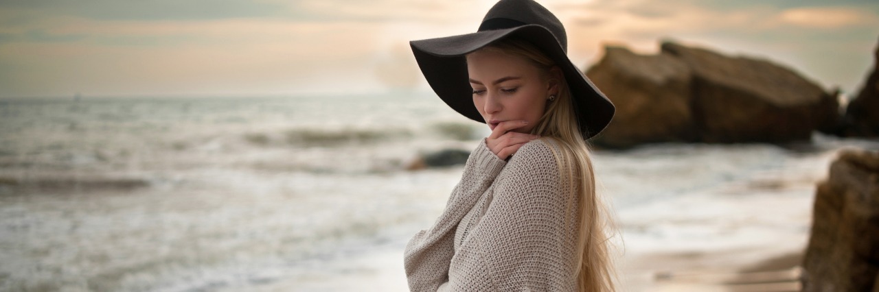 When I Said Goodbye to My Long Hair a Year After My Diagnosis Woman with long hair stand on the beach.