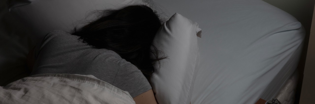 The Thoughts I Have During a Severe Pain Flare woman lying facedown on bed