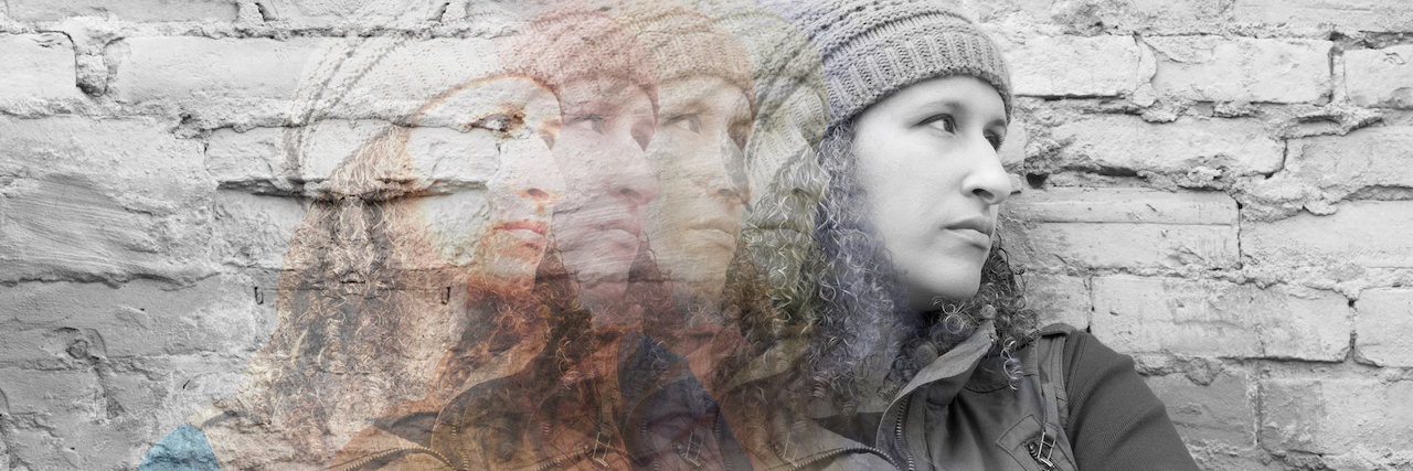 The Experience of a Psychiatric Intake for Bipolar A woman standing against a wall with her arms crossed