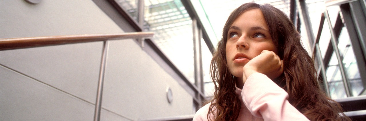 The Truth about Having Ehlers-Danlos Syndrome and POTS as a Teenager young girl sitting on steps in school building