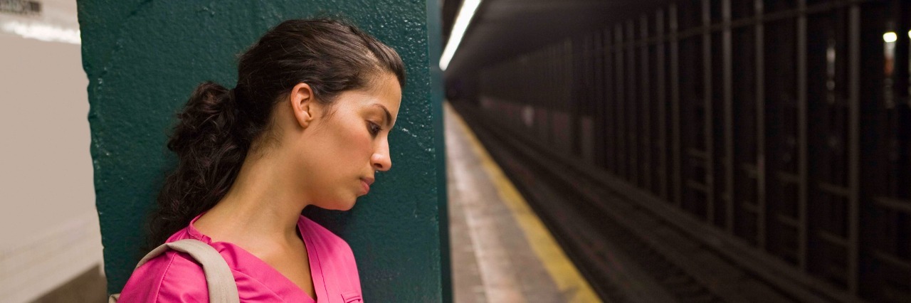 Why I Went Back to Nursing School as a Recovering Alcoholic Nurse waiting for subway reading book