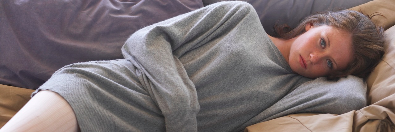Why Chronic Fatigue Is Different Than Being a Tired Teenager teen girl lying on sofa