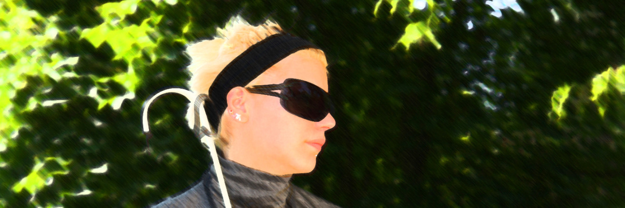 How Ableism Causes Suffering for People With Disabilities Blind woman sitting on a park bench on a sunny day.