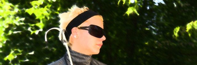 I Don't Suffer From Blindness. I Suffer From Ableism. Blind woman sitting on a park bench on a sunny day.