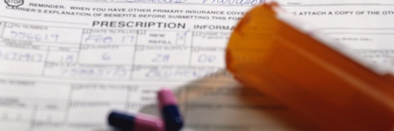 When My Health Insurance Said I Couldn't Take Lyrica Anymore insurance forms with bottle of pills spilled on top