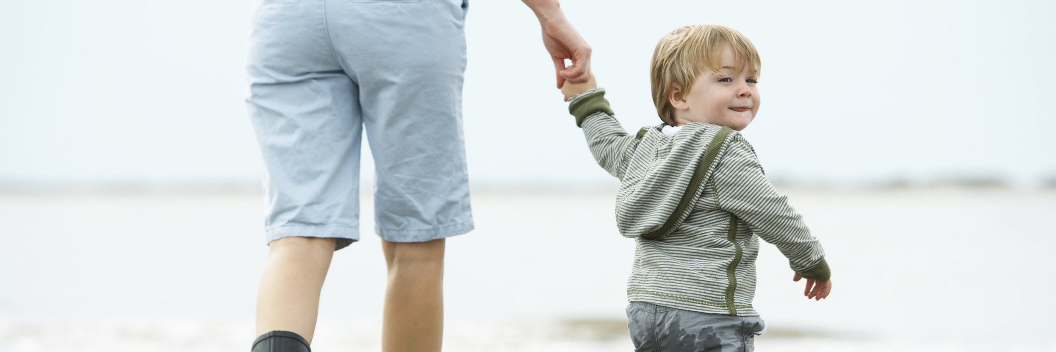 The Worries I Have About My Son as a Young Mom With Anxiety Mother and son (15-18 months) walking on beach, rear view