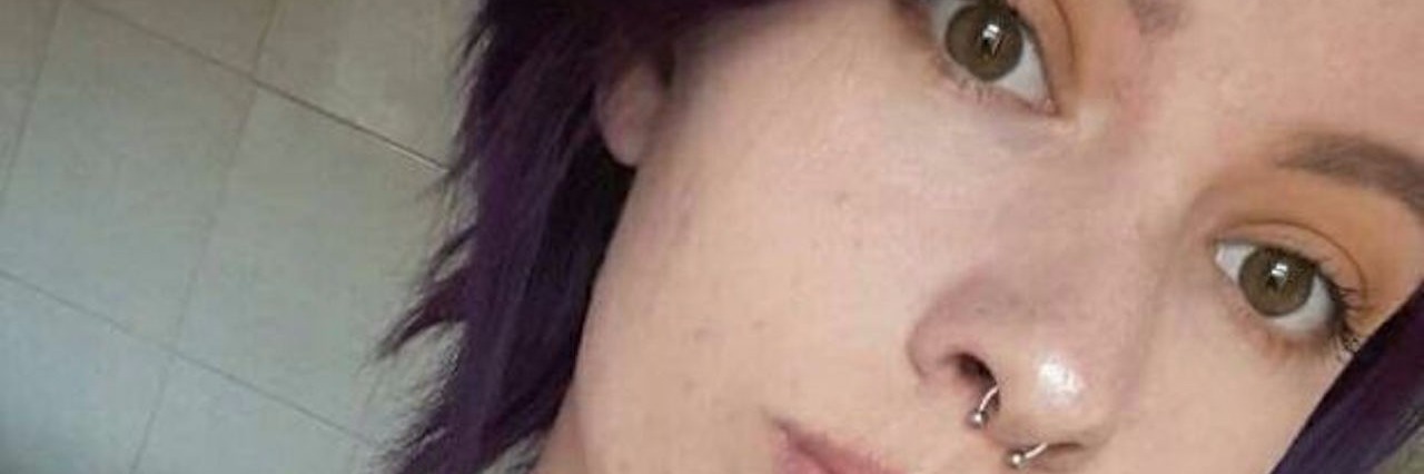 Being a College Student With Moderate Chronic Fatigue Syndrome selfie of college student with purple hair and necklaces and a caption that reads 'you think you're holy when you're not. I hate to break it to you baby, but your'e simply lost.'