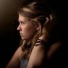 young woman in darkness looking depressed