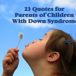 Little girl with Down syndrome blowing dandelion seeds to the wind.