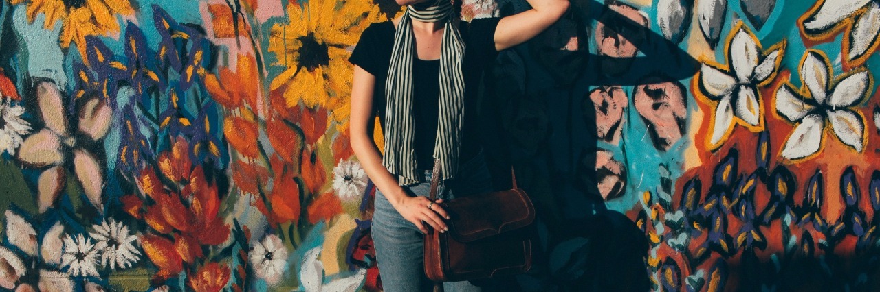 Struggling With Anxiety and Depression as an Introvert girl in front of flower wall