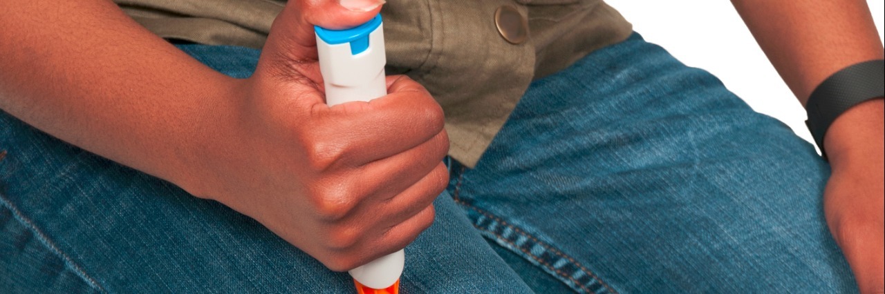 Having Anaphylaxis as a Nurse Because of a Latex Allergy torso and leg of a woman giving herself an emergency injection on her leg