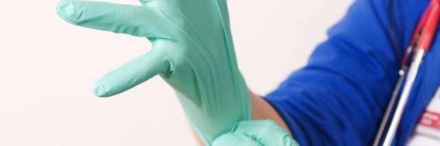 doctor pulling on latex gloves