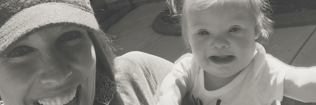 Going Through the 'Fire' With My Daughter's Open-Heart Surgery black and white photo of a mother and a daughter with Down syndrome smiling for the camera, close up of their faces.