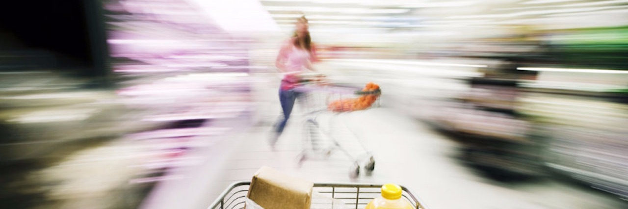 shopping cart in grocery store with blurry surroundings