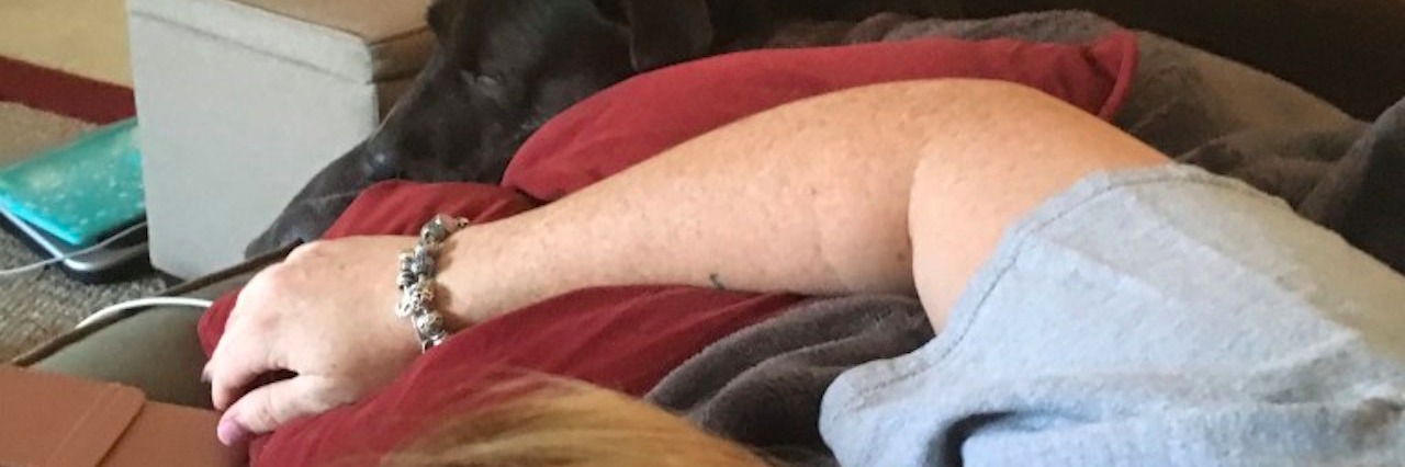 How My Husband Supports Me and My Addison's Disease woman lying on couch watching tv