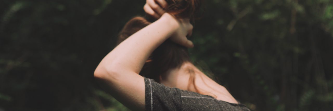 Is My Anxiety Real?: Questioning My Own Condition woman putting up her hair