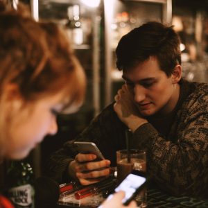 friends texting at dinner