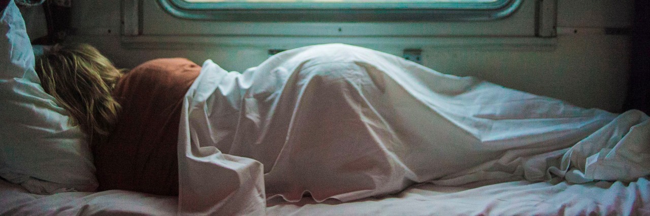 'Giving In' to My Migraine Pain Is Not the Same as 'Giving Up' woman asleep in bed