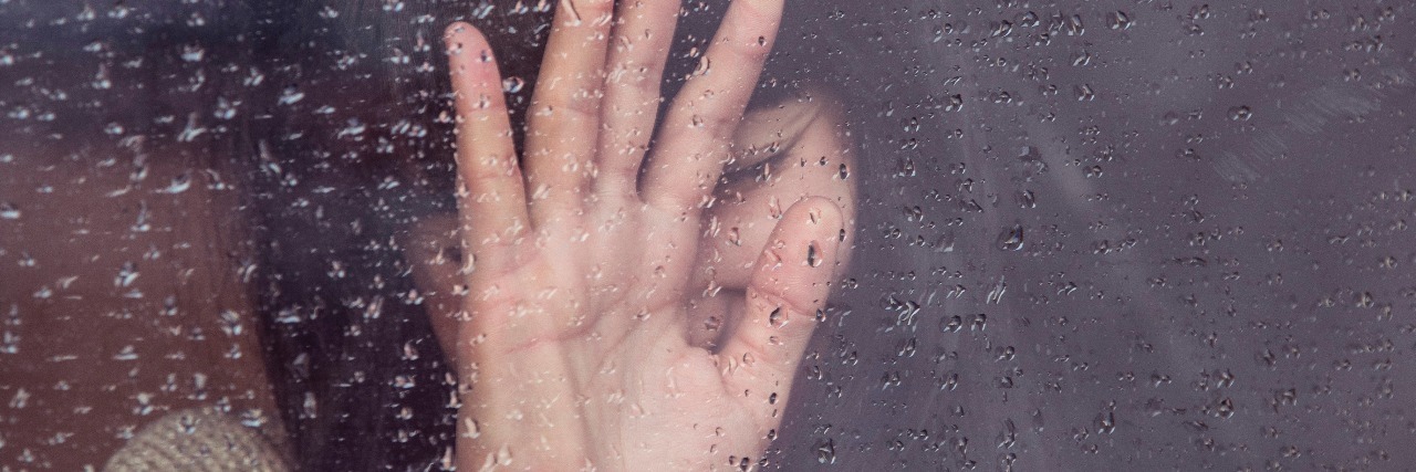 When Depression Is Like a Bubble You Can't Escape woman crying with hand pressed against window