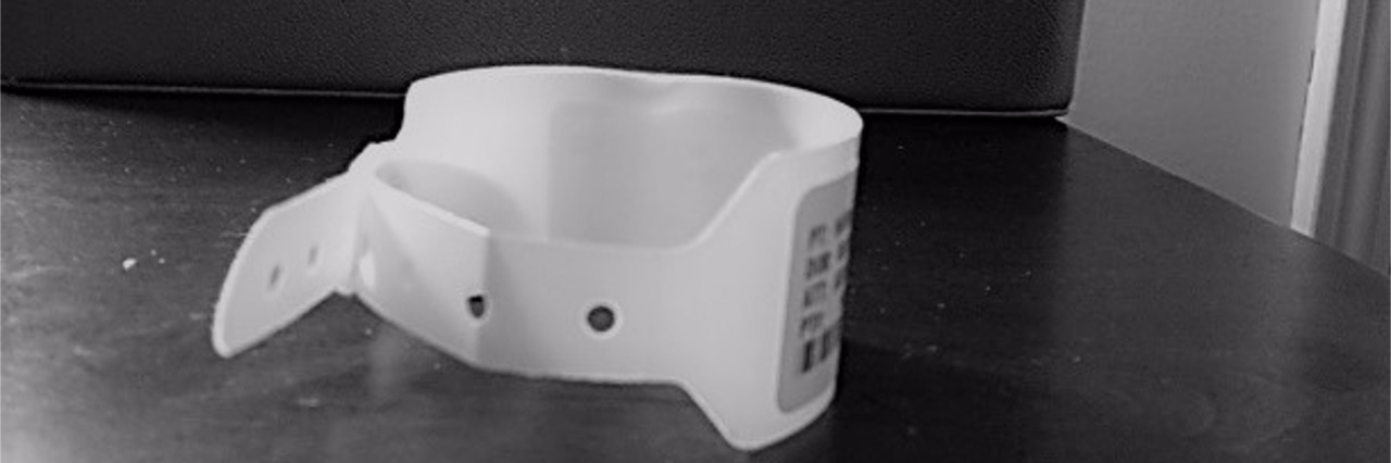 I Am More Than My Medical Diagnoses A white hospital bracelet off focus